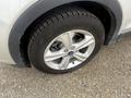 A close-up view of a silver 2014 Ford Escape wheel showcasing a five-spoke alloy rim and a black tire with tread patterns