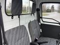 Interior view of a 2009 Suzuki Carry with two front seats featuring gray patterned fabric and headrests