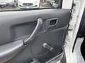 Interior door of a 2008 Suzuki Carry featuring a manual window crank handle and door lock button