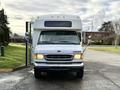 A 2002 Ford Econoline van facing forward with its front doors open and a white exterior