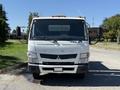 Front view of a 2015 Mitsubishi Fuso FE with a white exterior and prominent front grille featuring the brand logo headlights and side mirrors