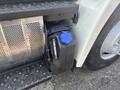 A blue capped tank on the side of a 2012 Hino 338 truck designed for diesel exhaust fluid storage