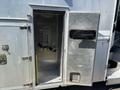 An open storage compartment on a 2008 Workhorse W62 displaying metal walls and a mounting bracket inside
