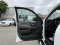 A 2016 GMC Sierra 1500 truck with the driver's door open showing the interior and door panel details