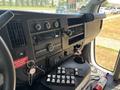 Interior dashboard of a 2020 Chevrolet Express featuring a radio system multiple buttons and controls and a key in the ignition