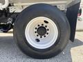 Close-up of a white wheel and tire from a 2015 Ford F-750 showcasing the wheel rim and tire tread pattern