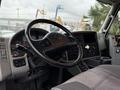 Interior view of a 2012 International 7400 truck showing the steering wheel dashboard and control panel