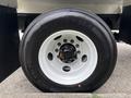 A close-up view of a 2025 Peterbilt 536 tire with a white rim showing the tread and bolt pattern