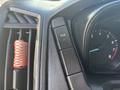 2017 Ford Transit-350 dashboard featuring buttons for TCS and air vent with a red elastic cord visible in the foreground