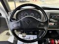 Interior view of a 2012 International DuraStar 4300 dashboard featuring a steering wheel and an instrument panel with various gauges and controls