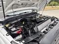 A 2013 Ford F-250 SD with its hood raised revealing the engine compartment showing various components like the battery and cooling system