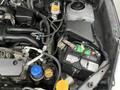 2016 Subaru Forester engine bay showing the battery various hoses and components