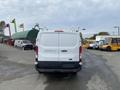 A 2017 Ford Transit van viewed from the rear with a white exterior and visible rear lights