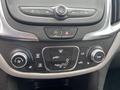 Interior control panel of a 2022 Chevrolet Equinox featuring climate control knobs buttons for air conditioning and defrost settings