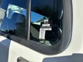 A close-up of a 2006 Freightliner M2 106 truck's rear window displaying a certificate of approval with various months listed
