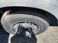 A close-up of a black tire with a stylized rim design mounted on a recreational vehicle