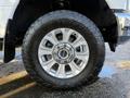 A close-up of a 2020 Ford F-350 wheel featuring a chrome five-spoke rim and a Toyo tire with an aggressive tread pattern