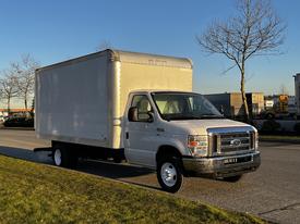 A white 2017 Ford Econoline box truck parked with a plain cargo area and large tires