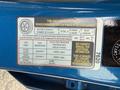 A tire and loading information label on the inside of a 2021 Kia Forte providing details on seating capacity and tire pressure specifications