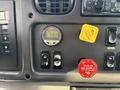 Dashboard controls of a 2013 Freightliner 114SD featuring gauges buttons and levers for various functions