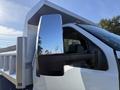 2017 Ford F-650 Super Duty truck with a large side mirror and a dump bed attached