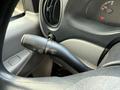 A close-up of the turn signal and wiper control stalk inside a 2002 Ford Econoline van showing various control settings and textured surface