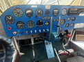 Cockpit of a 1986 Sorrell Hiperbipe SNS-7 with various analog gauges switches and levers arranged on a blue panel