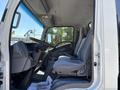 Interior view of a 2016 Isuzu NPR-HD showing front seats dashboard and steering wheel