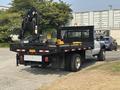 2009 Ford F-450 Super Duty flatbed truck equipped with a crane and tool box on the rear