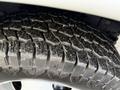 Close-up of a tire tread from a 2015 GMC Savana showing detailed grooves and patterns on the rubber surface