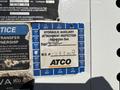 A blue inspection sticker attached to a vehicle displaying details about a hydraulic auxiliary attachment inspection and maintenance information