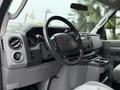 Interior of a 2013 Ford E-350 showing the steering wheel dashboard and control panel with various buttons and displays