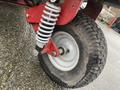 Close-up of the wheel and suspension system of a 2017 Ferris Rotary featuring a rugged tire and a coiled spring shock absorber