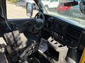 Interior view of a 2019 Chevrolet Express with a driver's seat dashboard controls and cup holders visible