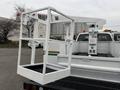 A white 2001 Ford F-350 truck with a lift bucket attached at the rear designed for aerial work