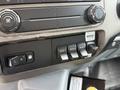 Control panel of a 2019 Ford F-750 displaying various buttons and knobs for auxiliary functions and climate control