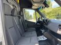 Interior view of a 2019 Mercedes-Benz Sprinter showing two front seats with a dashboard and steering wheel visible