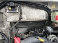 Close-up view of the engine compartment of a 2012 Workhorse W62 showing wires cables and components with visible wear and tear