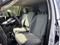 Interior of a 2013 RAM 5500 showing two front seats in gray fabric with a steering wheel and console visible