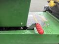 A green John Deere 2653B Precision Diesel Mower with a red lever and various operational labels visible on the surface