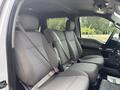 Interior view of a 2017 Ford F-150 showing front seats with seat belts and gray fabric upholstery