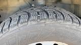 A close-up of a tire tread on a 2021 Ford Transit showcasing the detailed patterns and grooves designed for traction and stability