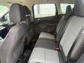 Interior view of a 2014 Ford Escape showing the back seat with two rows of seating and black fabric upholstery