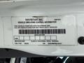 A vehicle emissions control information label from a 2022 International MV607 truck detailing compliance with environmental regulations and specifications for the vehicle model