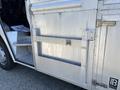 A 2008 Workhorse W62 vehicle with a metallic exterior featuring a side door and a latch mechanism