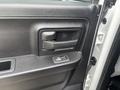 Interior door handle of a 2016 RAM 1500 with a textured black surface and a rectangular shape