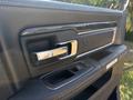 Interior door handle and control panel of a 2018 RAM 3500 with chrome accents and a sleek design