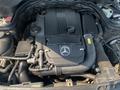 A 2013 Mercedes-Benz C-Class engine displayed in an open hood with various components including an air intake and fluid reservoir