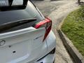 A 2021 Toyota C-HR with a white exterior and distinctive rear design featuring a limited badge and sleek taillights