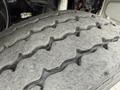 Close-up view of a worn tire tread on a 2016 Peterbilt 348 showing deep grooves and grooves that indicate usage and wear